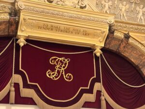 Interior detail of Richmond Theatre with the inscription “To wake the soul by tender strokes of art” above the proscenium arch.