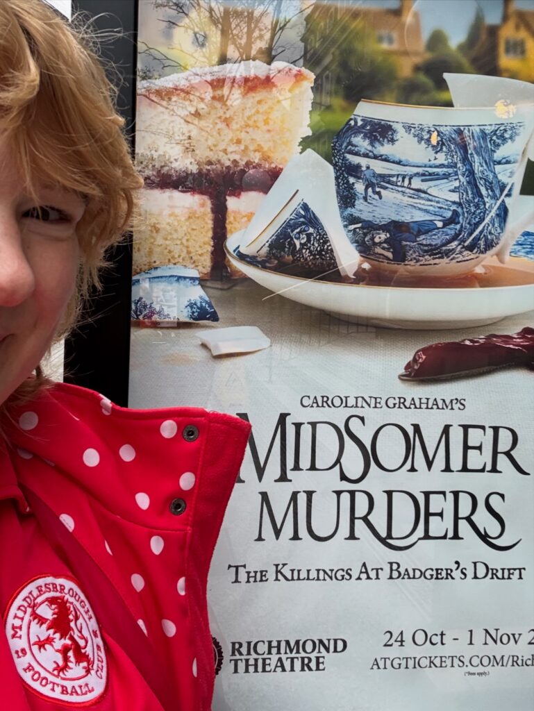 Petra next to a poster for Midsomer Murders: The Killings at Badger’s Drift outside Richmond Theatre.
